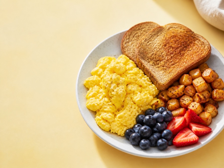 Scrambled eggs, toast, potatoes, and berries for breakfast-for-dinner.